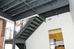 Metal stair case, historic brick architecture, hardwood ceilings