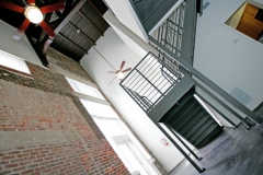 Metal stair case, historic brick architecture, hardwood ceilings