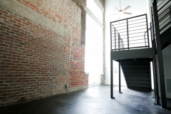 Second floor metal staircase leading to loft bedroom area at The Lofts San Marco