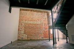 Historic brick construction with contemporary metal staircase to second floor