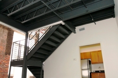 Old brick and new metal staircase at The Lofts San Marco, contemporary kitchen